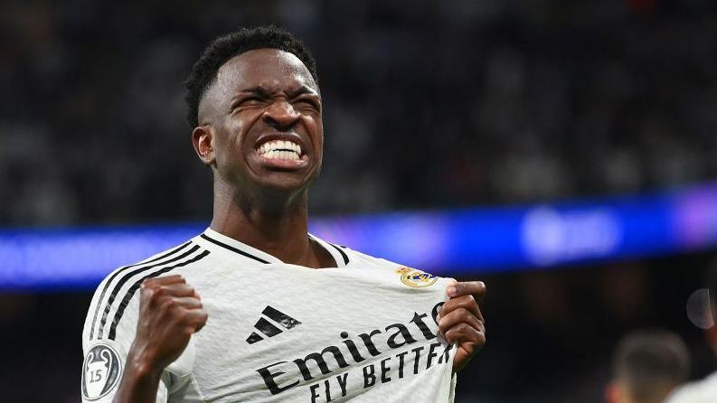 'Vinicius smiling again but his future has never been more uncertain' 4 Vinicius Junior celebrates while wearing Real Madrid's white shirt and grabbing close to the club badge